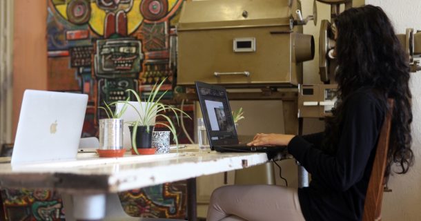 Woman working on laptop in co-working space